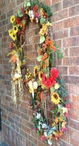 Double the impact-Two grapevine wreaths attached together with loads of Fall florals